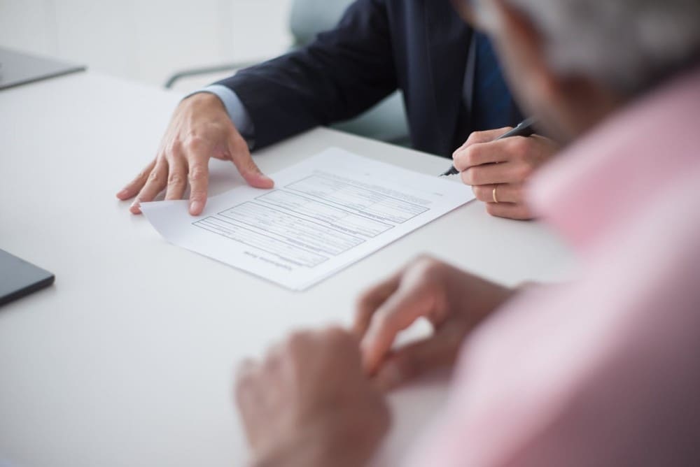 A business owner, with help from an accounting firm, carefully gathers important documents in preparation for an upcoming IRS audit of the business.